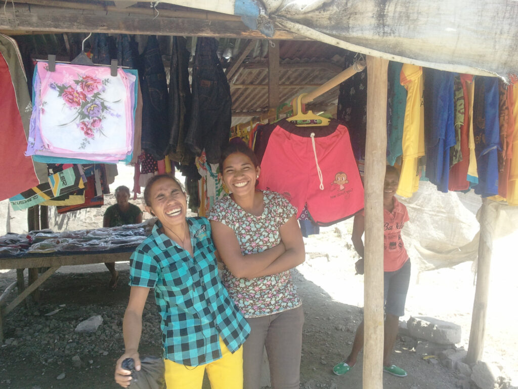 Girls selling second hand clothes at the market in Dili, East Timor